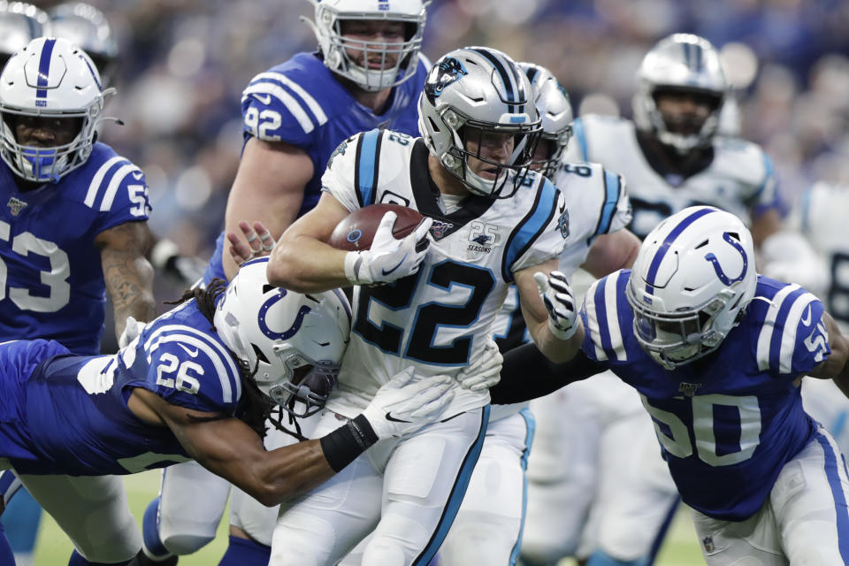 Carolina Panthers' Christian McCaffrey (22) is tackled by Indianapolis Colts' Clayton Geathers (26) and Anthony Walker (50) during the first half of an NFL football game, Sunday, Dec. 22, 2019, in Indianapolis. (AP Photo/Michael Conroy)