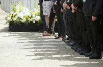 People observe a minute's silence at the memorial to victims of the July 7, 2005 London bombings, in Hyde Park, central London, Britain July 7, 2015. Britain fell silent on Tuesday to commemorate the 10th anniversary of attacks targeting London public transport which killed 56 people, the first suicide bombings by Islamist militants in western Europe. (REUTERS/Peter Nicholls)