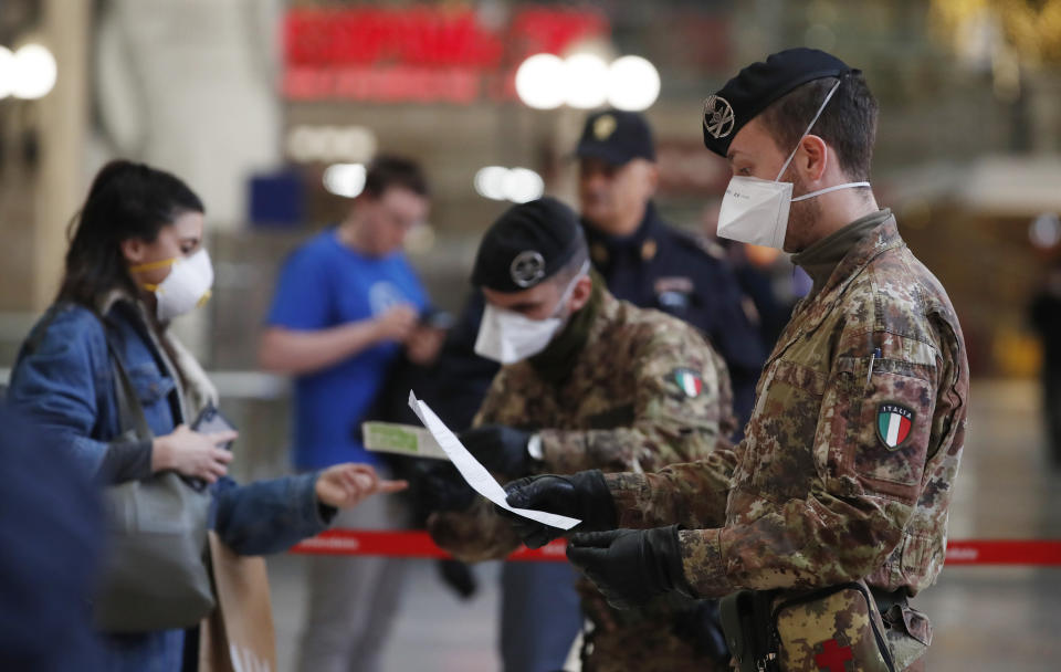 Police officers and soldiers check passengers leaving from Milan main train station, Italy, Monday, March 9, 2020. Italy took a page from China's playbook Sunday, attempting to lock down 16 million people — more than a quarter of its population — for nearly a month to halt the relentless march of the new coronavirus across Europe. Italian Premier Giuseppe Conte signed a quarantine decree early Sunday for the country's prosperous north. Areas under lockdown include Milan, Italy's financial hub and the main city in Lombardy, and Venice, the main city in the neighboring Veneto region. (AP Photo/Antonio Calanni)