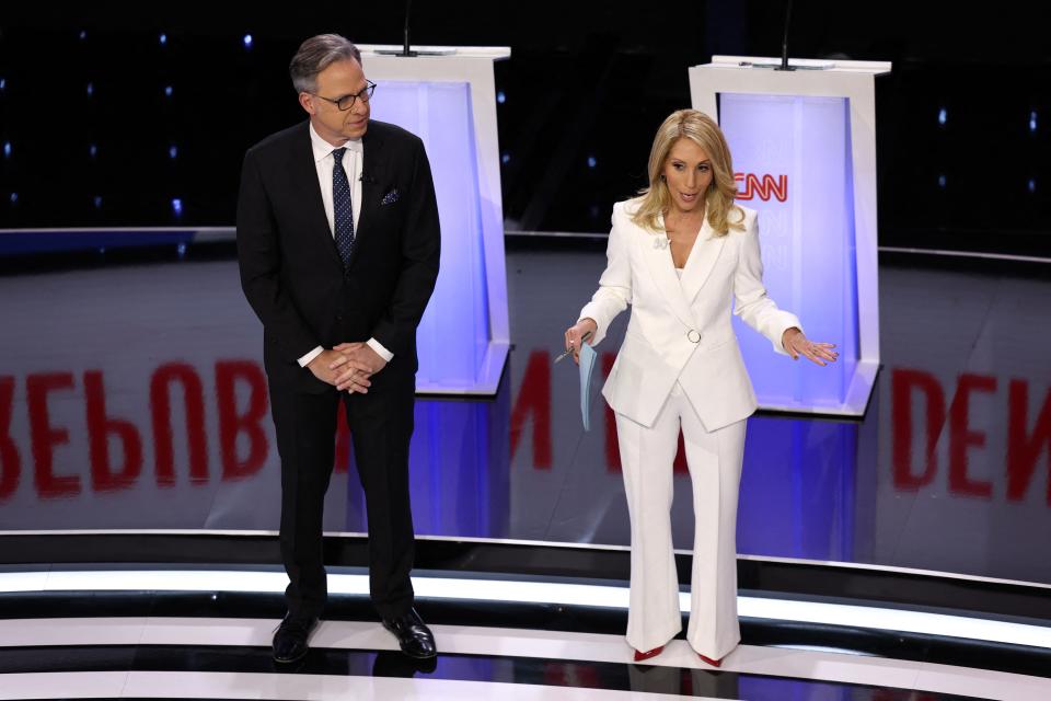 Moderators Jake Tapper and Dana Bash speak to the audience before the start of the Republican candidates' presidential debate hosted by CNN at Drake University in Des Moines, Iowa on January 10, 2024.