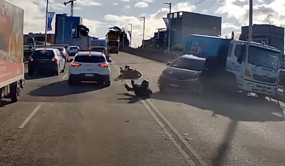 A truck ran into the car, which then accidentally ran over the motorcyclist. Source: Dash Cam Owners Australia