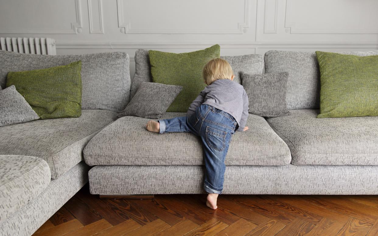 Toddler climbing on furniture - Copyright (c) 2016 Rex Features. No use without permission.