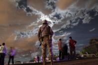 A soldier stands guard near a crime scene in Loma Blanca on the outskirts of Ciudad Juarez September 22, 2013. At least nine people consisting of seven men, two women and a girl, were executed with bullets by an unknown criminal group outside a car mechanic's workshop, according to local media. (REUTERS/Jose Luis Gonzalez)