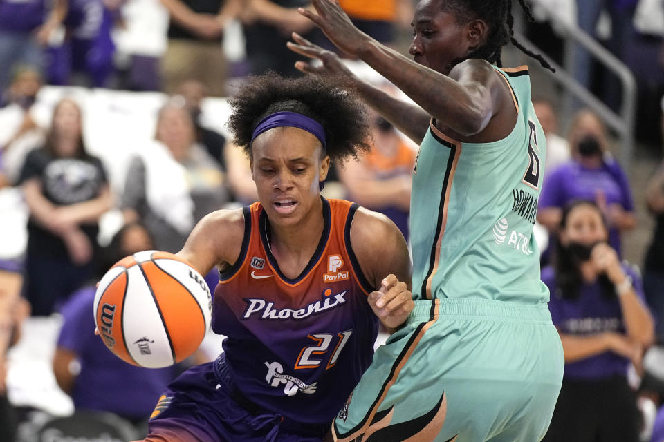 Phoenix Mercury forward Brianna Turner (21) drives past New York Liberty forward Natasha Howard during the first half in the first round of the WNBA basketball playoffs, Thursday, Sept. 23, 2021, in Phoenix. (AP Photo/Rick Scuteri)