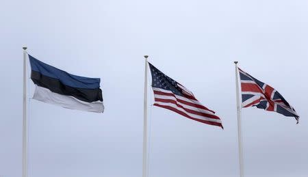 Flags of Estonia, the U.S. and Britain flutter in the Estonian army base in Tapa, Estonia February 16, 2017. Picture taken February 16, 2017. REUTERS/Ints Kalnins