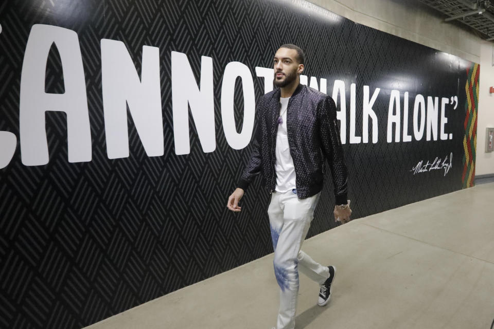 Utah Jazz center Rudy Gobert arrives at the Vivint Smart Home Arena before the start of their NBA basketball game against the Denver Nuggets Wednesday, Feb. 5, 2020, in Salt Lake City. (AP Photo/Rick Bowmer)