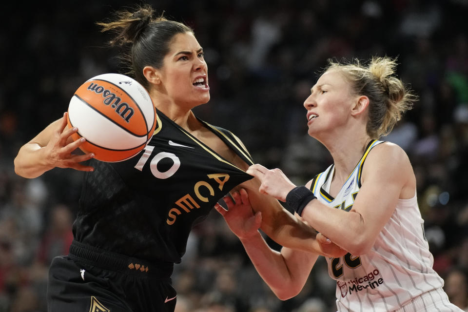 Chicago Sky guard Courtney Vandersloot, right, fouls Las Vegas Aces guard Kelsey Plum (10) during the second half of a WNBA basketball game Tuesday, June 21, 2022, in Las Vegas. (AP Photo/John Locher)