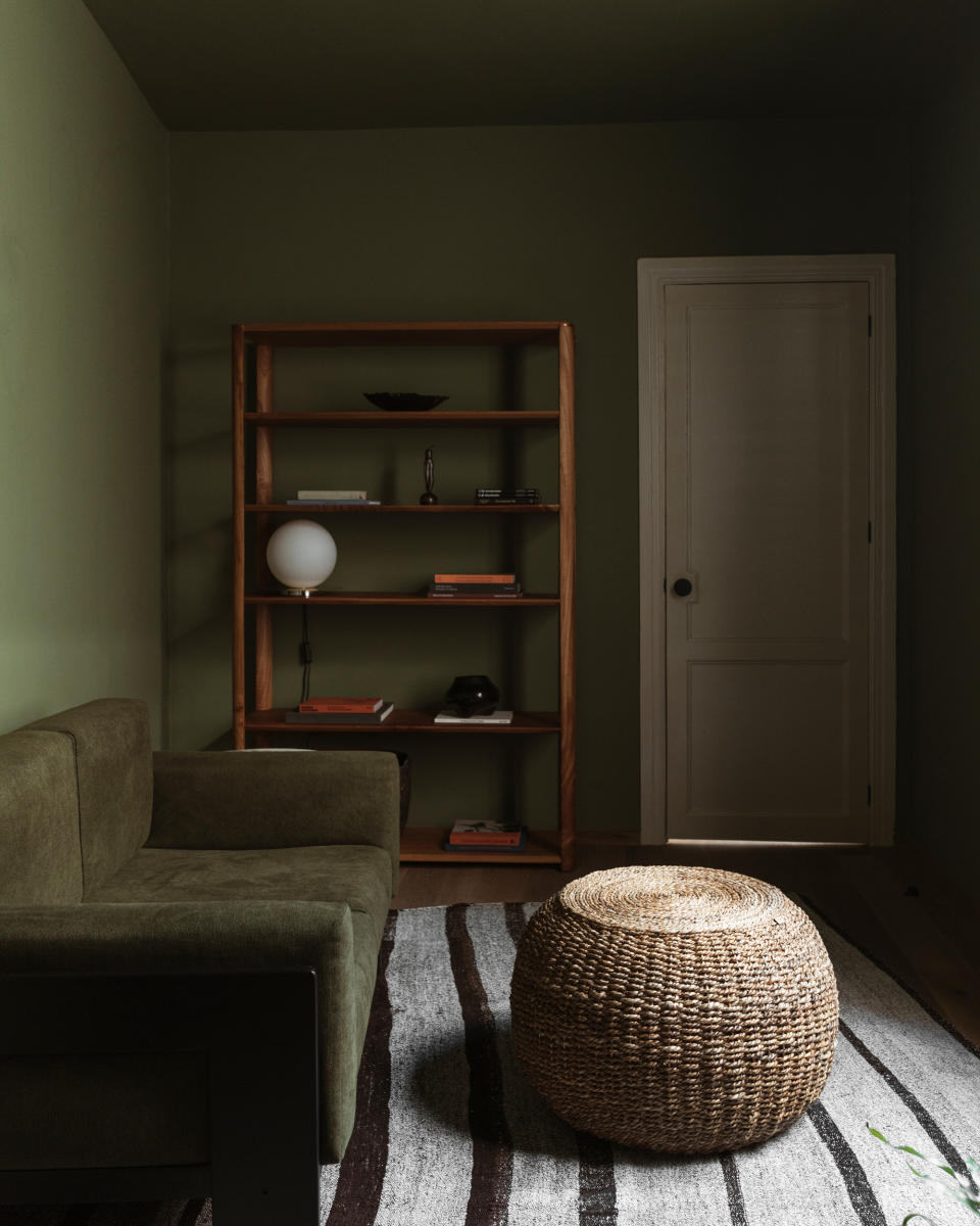 a color drenched small green living room