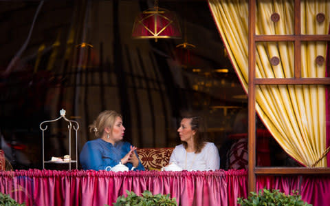 Two ladies taking afternoon tea at a hotel on Buckingham Palace Road in London.  - Credit: Neil Perry /This Is Britain