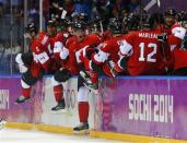 Canada's players celebrate their men's ice hockey semi-final victory over Team USA at the Sochi 2014 Winter Olympic Games, February 21, 2014. REUTERS/Laszlo Balogh