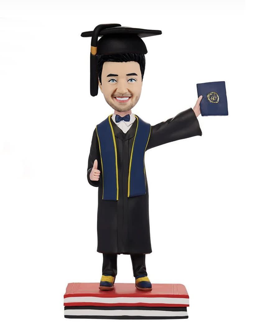 <p><a href="https://go.redirectingat.com?id=74968X1596630&url=https%3A%2F%2Fwww.bobblegifts.com%2Fcollections%2Fgraduation-gifts%2Fproducts%2Fgraduation-photo-bobbleheads-craft&sref=https%3A%2F%2Fwww.thepioneerwoman.com%2Fhome-lifestyle%2Fg36124040%2Fgraduation-gifts-for-boys%2F" rel="nofollow noopener" target="_blank" data-ylk="slk:Shop Now;elm:context_link;itc:0;sec:content-canvas" class="link ">Shop Now</a></p><p>Personalized Graduation Bobblehead</p><p>$78.00</p><span class="copyright">Bobblegifts</span>