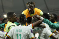 Senegal players celebrate scoring their side's second goal during the World Cup group A soccer match between Ecuador and Senegal, at the Khalifa International Stadium in Doha, Qatar, Tuesday, Nov. 29, 2022. (AP Photo/Francisco Seco)