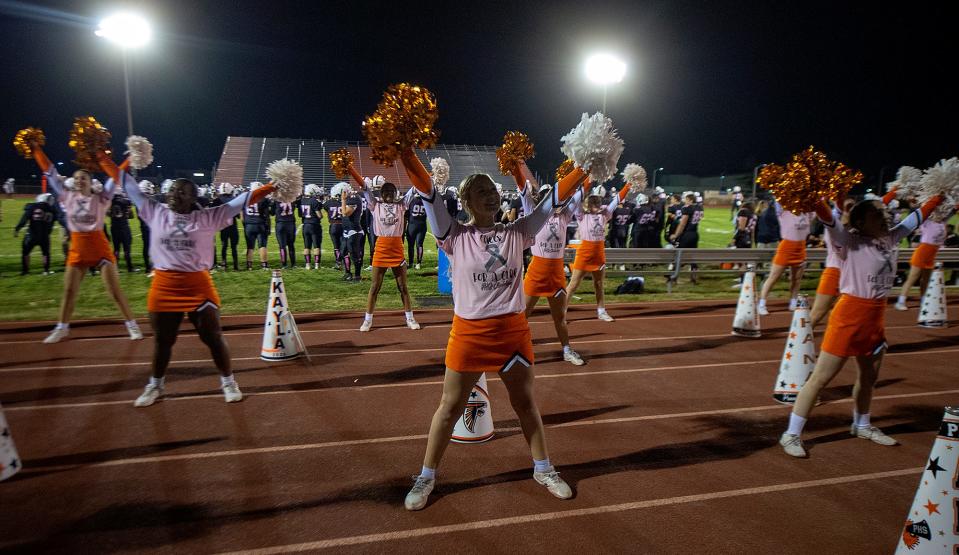 Pennsbury cheerleaders pump up the crowd during the the school's first game back at Falcon Field this season Friday, Oct. 21, 2022.