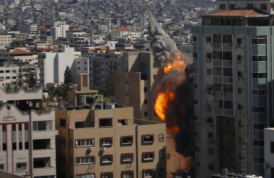 An Israeli airstrike hits the high-rise building housing The Associated Press' offices in Gaza City, Saturday, May 15, 2021. The airstrike Saturday came roughly an hour after the Israeli military ordered people to evacuate the building. The building housed The Associated Press, Al-Jazeera and a number of offices and apartment. (AP Photo/Hatem Moussa)