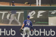 Texas Rangers left fielder Eli White watches a home run by Los Angeles Angels' Albert Pujols fall on the other side of the fence during the fifth inning of a baseball game Friday, Sept. 18, 2020, in Anaheim, Calif. (AP Photo/Ashley Landis)