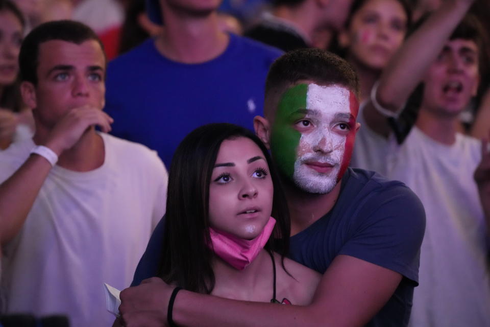 Fans watch on a giant screen in Rome, Sunday, July 11, 2021, the Euro 2020 soccer championships' final match between Italy and England played at Wembley stadium in London. (AP Photo/Gregorio Borgia)