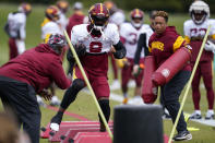 Washington Commanders running back Brian Robinson Jr., works out during practice at the team's NFL football training facility, Wednesday, Oct. 5, 2022, in Ashburn, Va. Robinson was shot twice in the right leg Aug. 28 in Washington, was taken to a hospital, underwent surgery and was released a day later. The bullets missed all the major ligaments and bones in his knee. (AP Photo/Alex Brandon)