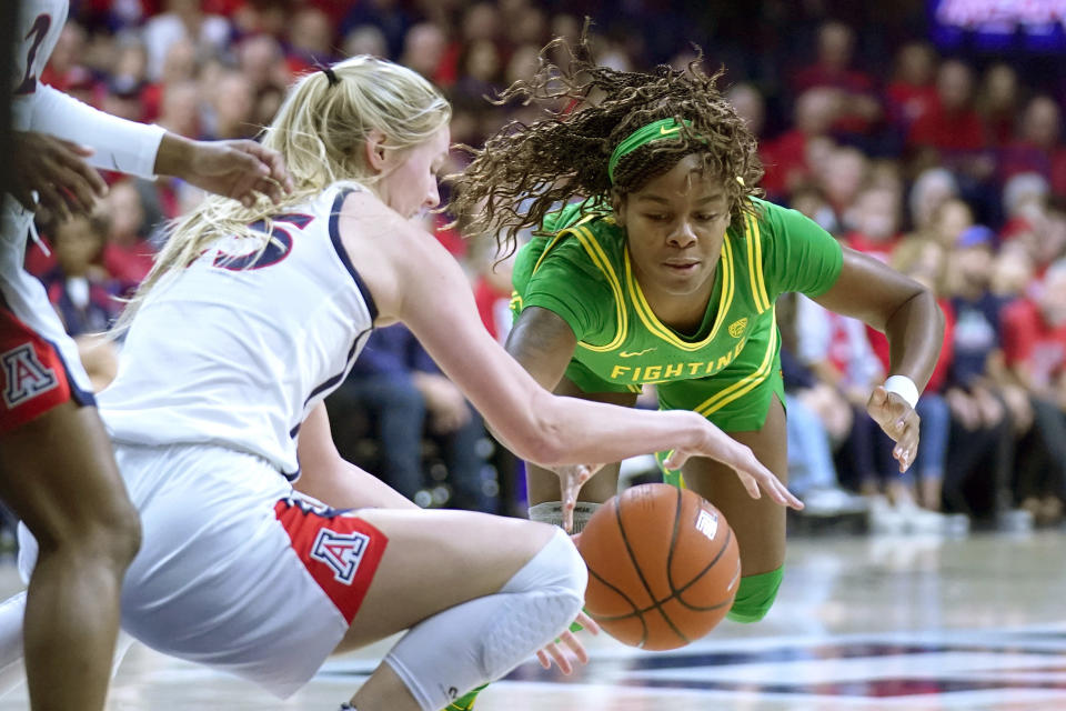 Oregon forward Ruthy Hebard, right, and Arizona forward Cate Reese (25) battle for the ball during the first half of an NCAA college basketball game Sunday, Jan. 12, 2020, in Tucson, Ariz. (AP Photo/Rick Scuteri)
