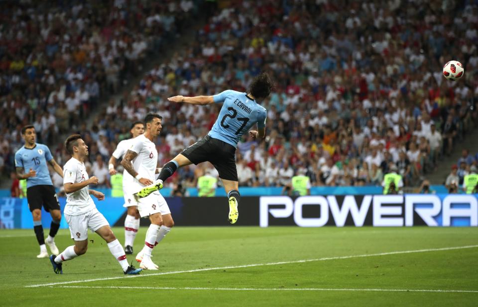 <p>Edinson Cavani scores a Sochi schorcher with his head to give Uruguay a 1-0 first-half lead against Portugal </p>