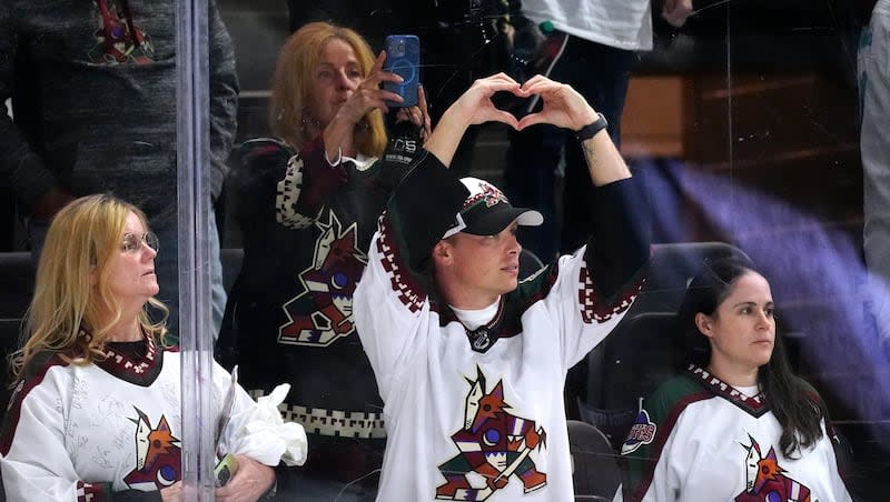 Arizona Coyotes fans watch players acknowledge the crowd after the Coyotes' NHL hockey game against the Edmonton Oilers on Wednesday, April 17, 2024, in Tempe, Ariz. The Coyotes won 5-2.