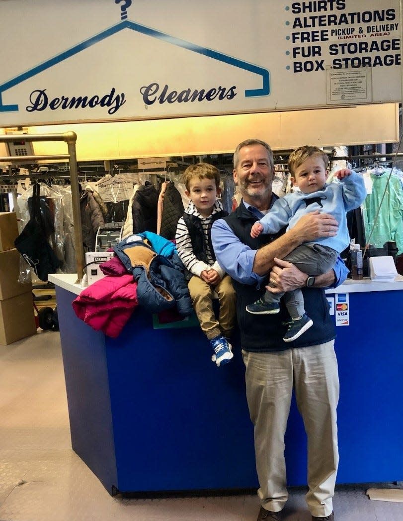Dermody Cleaners owner Terry Dermody holds his grandsons, Emmett (left) and Brooks Dermody.
