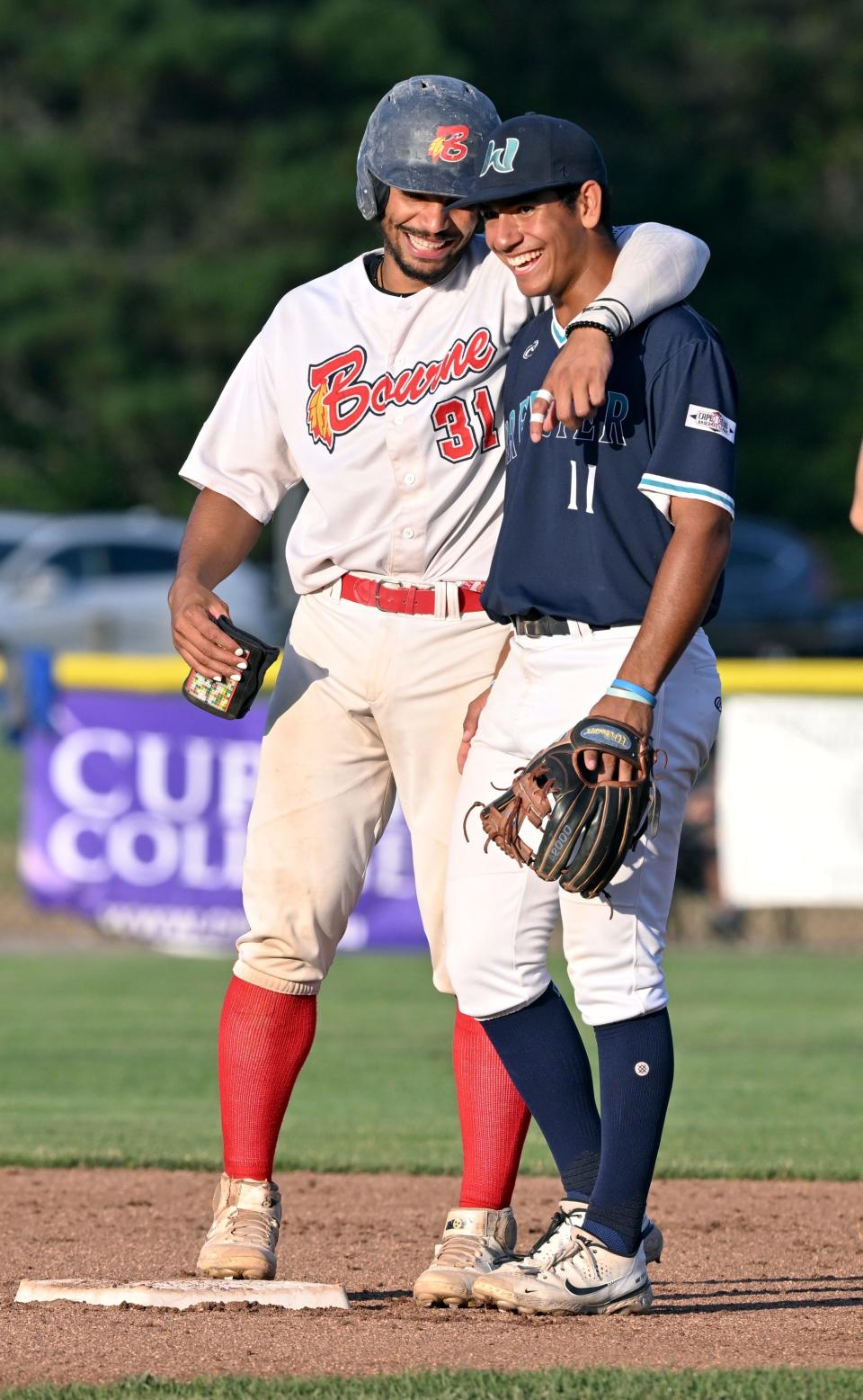 Vanderbelt teammates Davis Diaz of Brewster and Alan Espinal of Bourne share a moment after Espinal safely arrives at second during Wednesday's game in Bourne.