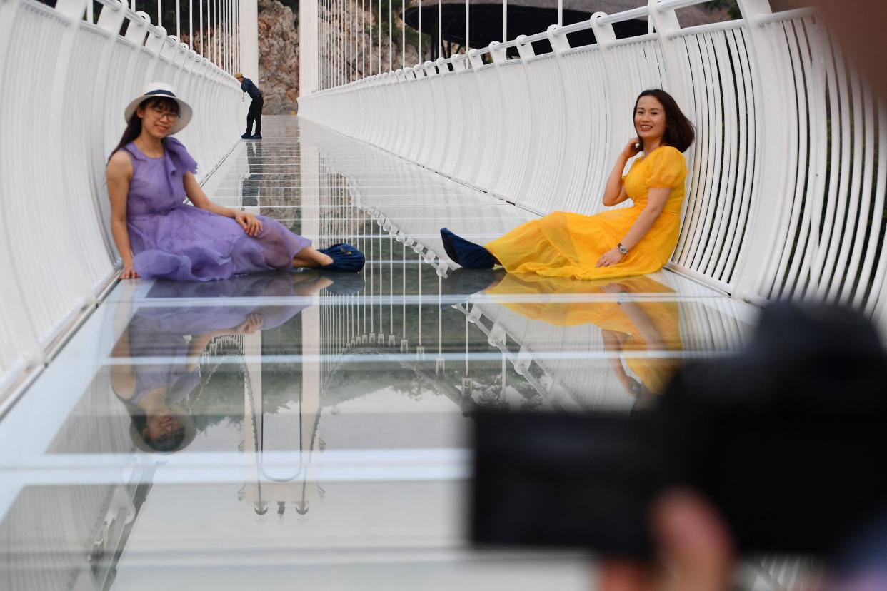 people sit down on the Bach Long glass bridge in the Moc Chau district in Vietnam's Son La province
