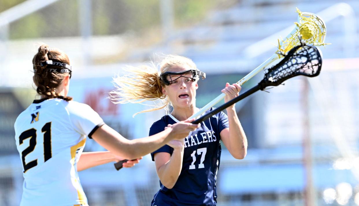 NORTH EASTHAM  5/18/23  Bailey Lower of Nantucket  prepares to fire  a shot past Gabby Foster of Nauset.