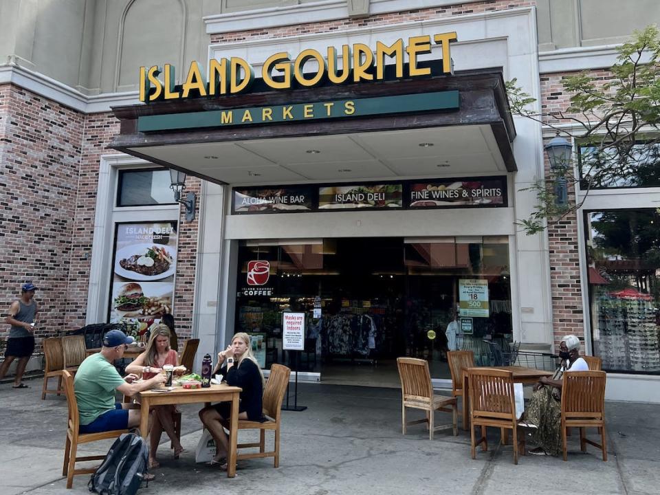 outside of island gourmet market, with people sitting at tables