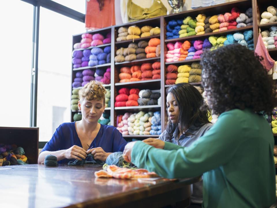 women knitting in yarn store