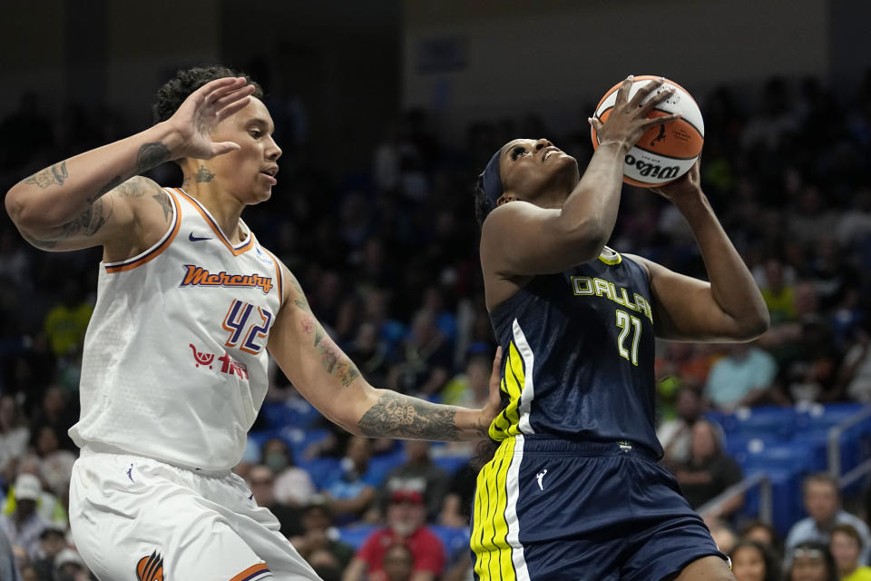 Dallas Wings center Kalani Brown (21) shoots next to Phoenix Mercury center Brittney Griner during the first half of a WNBA basketball game Wednesday, June 7, 2023, in Arlington, Texas. (AP Photo/Tony Gutierrez)