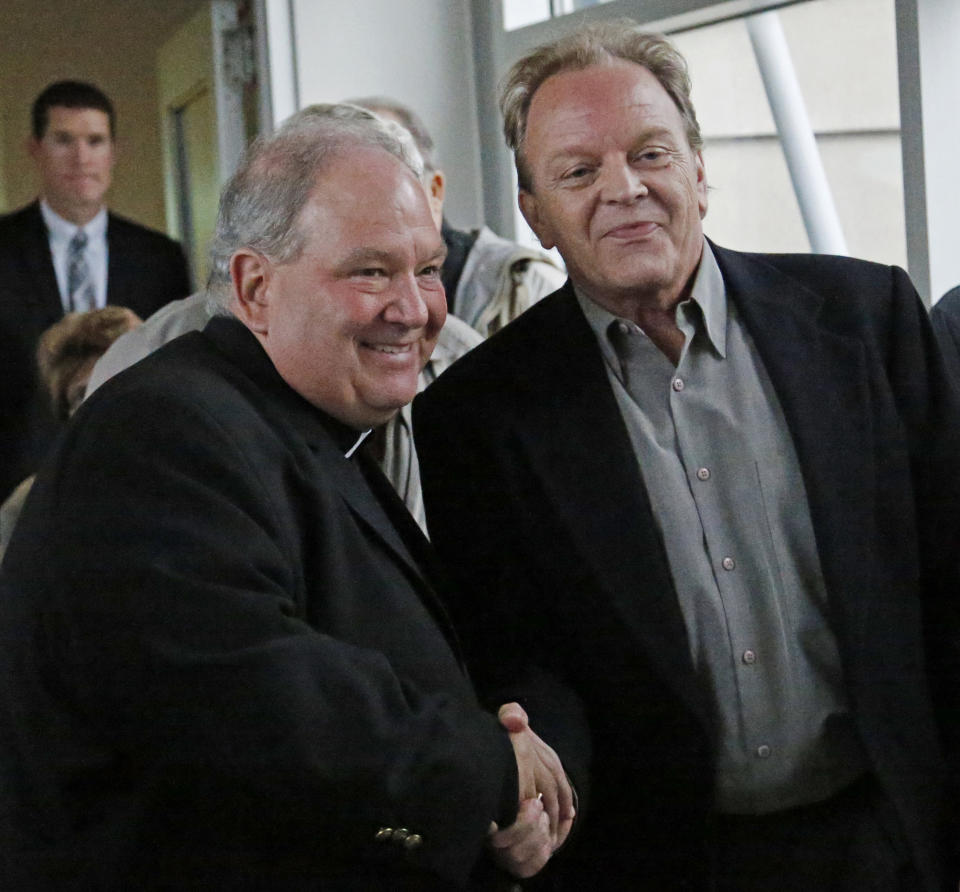 Archbishop Bernard Hebda, left, and clergy abuse survivor Jamie Heutmaker shook hands after a U.S. Bankruptcy Court approved a settlement plan that includes $210 million for victims of clergy sex abuse Tuesday, Sept. 25, 2018, in Minneapolis. A U.S. Bankruptcy Court judge has approved a reorganization plan for the Archdiocese of St. Paul and Minneapolis that will compensate victims of clergy sex abuse. Hundreds of victims voted overwhelmingly in favor of the plan. (Shari L. Gross/Star Tribune via AP)