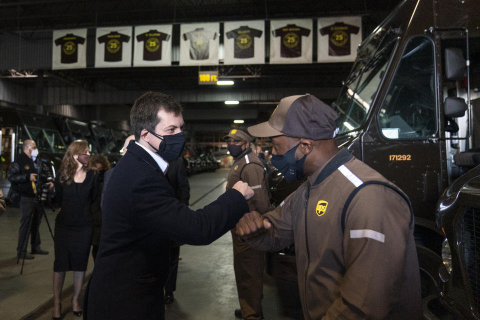 Transportation Secretary Pete Buttigieg greets UPS driver Ricardo Adams during a tour of a UPS Facility in Landover, Md., Monday, March 15, 2021. Buttigieg was on hand to highlight COVID-19 vaccine distribution distribution efforts.(AP Photo/Carolyn Kaster)