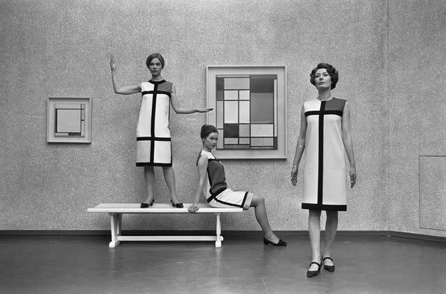 <p>Sepia Times/ Universal Images Group via Getty Images</p> Models in YSL Mondrian dresses