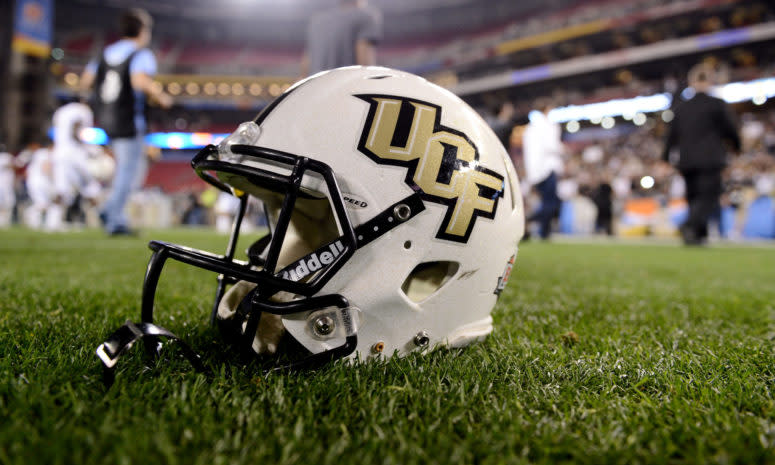 A UCF football helmet placed on the field.