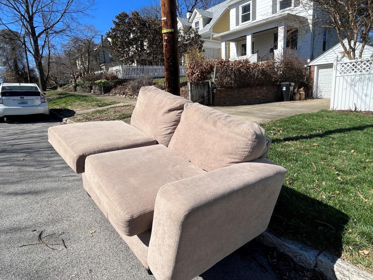 Part of a sectional sofa out for junk pickup in Crescent Hill.