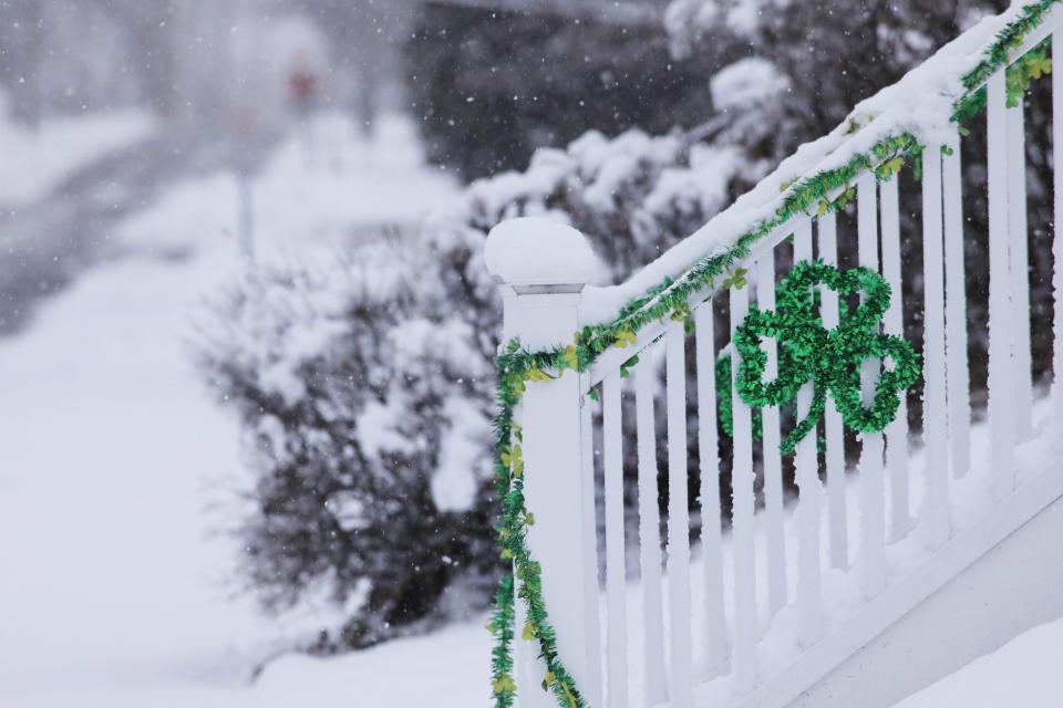 Saint Patrick's Day decorations adorn a railing in the village of Wappingers Falls during Tuesday's snow storm on March 14, 2023.