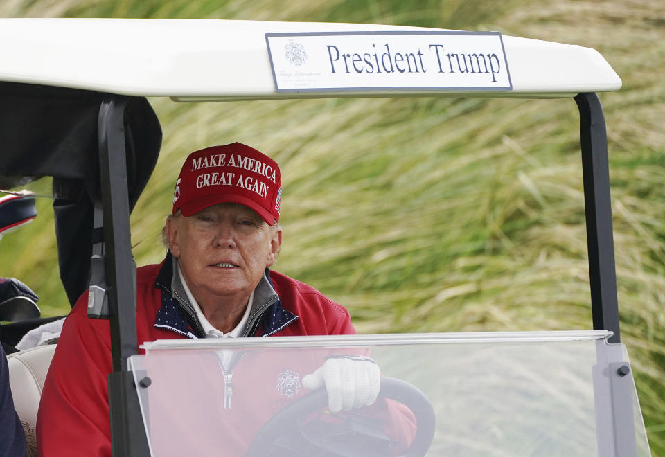 Former US president Donald Trump drives in a buggy during a round of golf at Trump International Golf Links & Hotel in Doonbeg, Ireland, Thursday, May 4, 2023, during his visit to Ireland. (Brian Lawless/PA via AP)