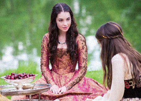 This image released by The CW shows Adelaide Kane as Mary, Queen of Scots, left, and Caitlin Stasey as Kenna in a scene from the new series "Reign," premiering Thursday, Oct. 17, 2013. (AP Photo/The CW, Christos Kalohoridis)