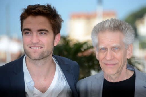 British actor Robert Pattinson (L) and Canadian director David Cronenberg pose during the photocall of "Cosmopolis" presented in competition at the 65th Cannes film festival in Cannes, May 25. The Manhattan thriller, adapted from Don DeLillo's 2003 novel, follows a day in the life of Eric Packer while he journeys through a city in turmoil as the US president makes a visit