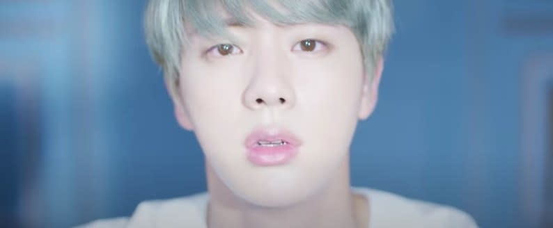 Close-up of Jin staring emotionally at the camera