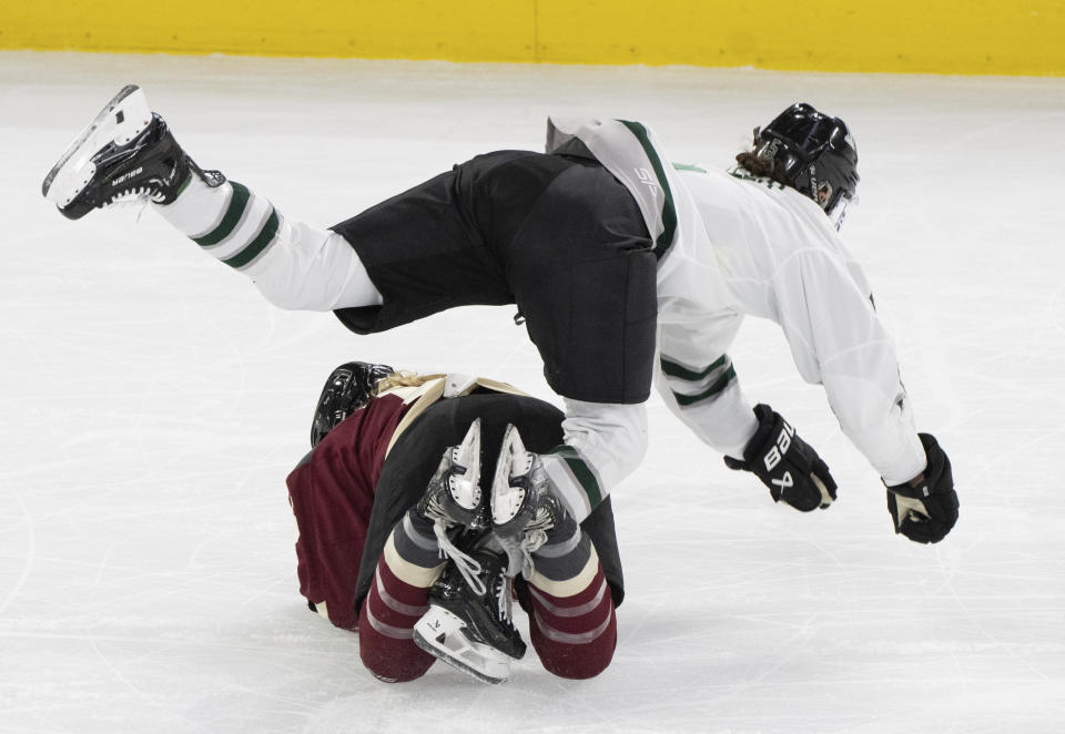 Boston's Megan Keller, top, trips over Montreal's Maureen Murphy, bottom, during first-period PWHL playoff hockey game action in Laval, Quebec, Saturday, May 11, 2024. (Christinne Muschi/The Canadian Press via AP)