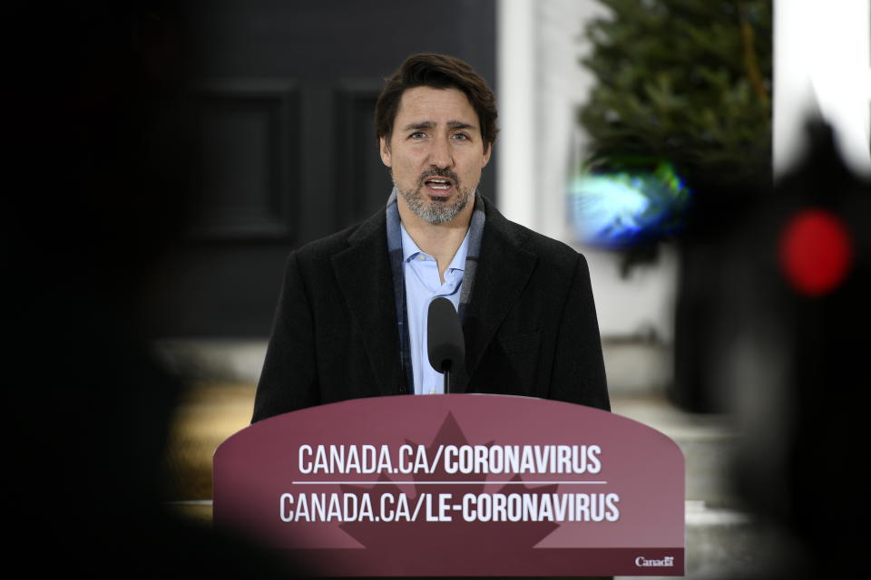 Prime Minister Justin Trudeau speaks during his daily press conference on COVID-19, in front of his residence at Rideau Cottage, on the grounds of Rideau Hall in Ottawa, on Saturday, March 28, 2020. (Justin Tang/The Canadian Press via AP)