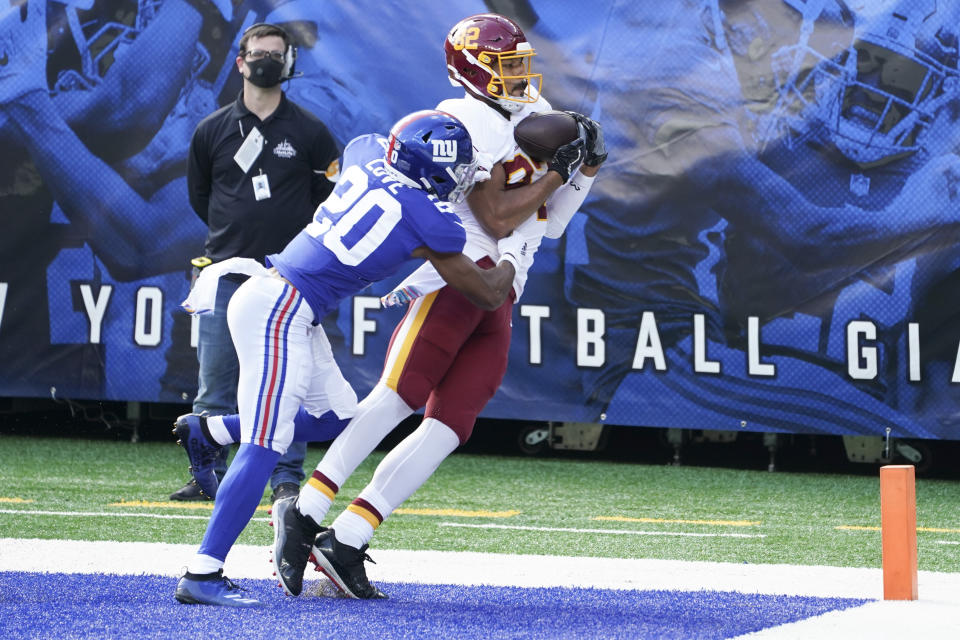Washington Football Team's Logan Thomas (82) catches a pass for a touchdown in front of New York Giants' Julian Love (20) during the first half of an NFL football game Sunday, Oct. 18, 2020, in East Rutherford, N.J. (AP Photo/John Minchillo)