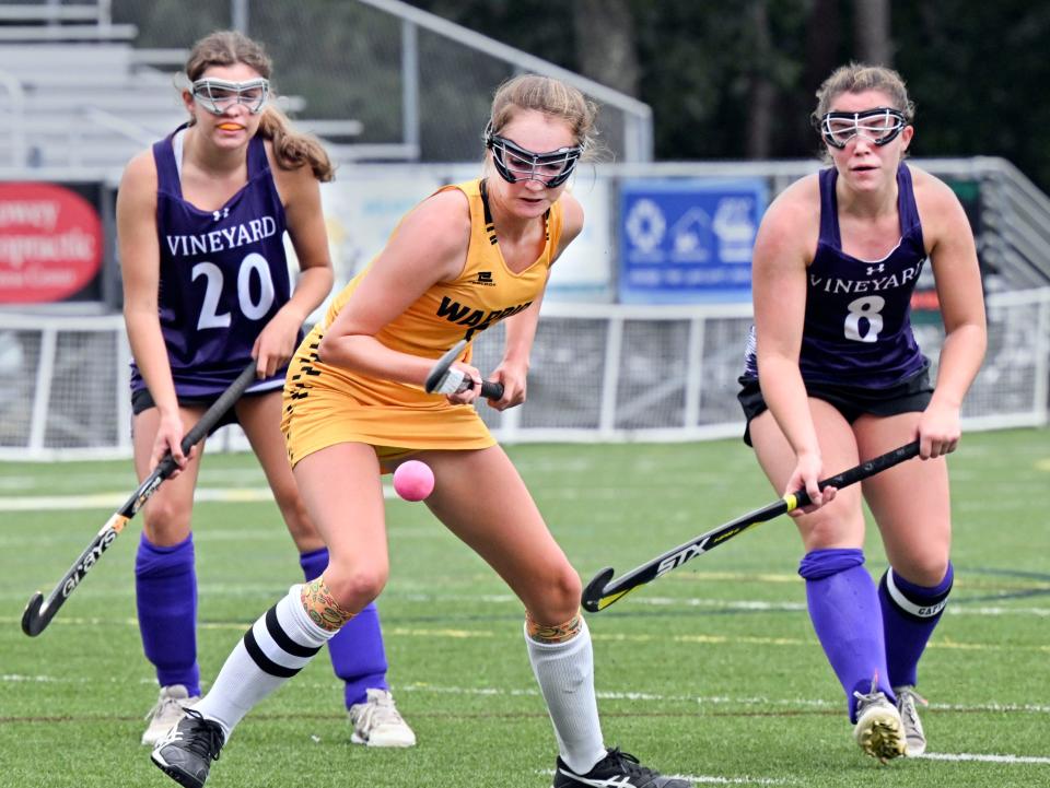 Christin Schadt of Nauset watches the ball bounce up with Charlotte Scott (20) and Mellie Long of Martha's Vineyard during field hockey in North Eastham Wednesday.