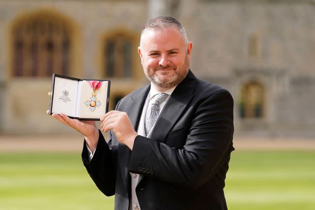 <p>ANDREW MATTHEWS/POOL/AFP via Getty</p> Conservative MP for Pendle, Andrew Stephenson smiles following being eing appointed a Commander of the Order of the British Empire in an investiture at Windsor Castle on Oct. 4