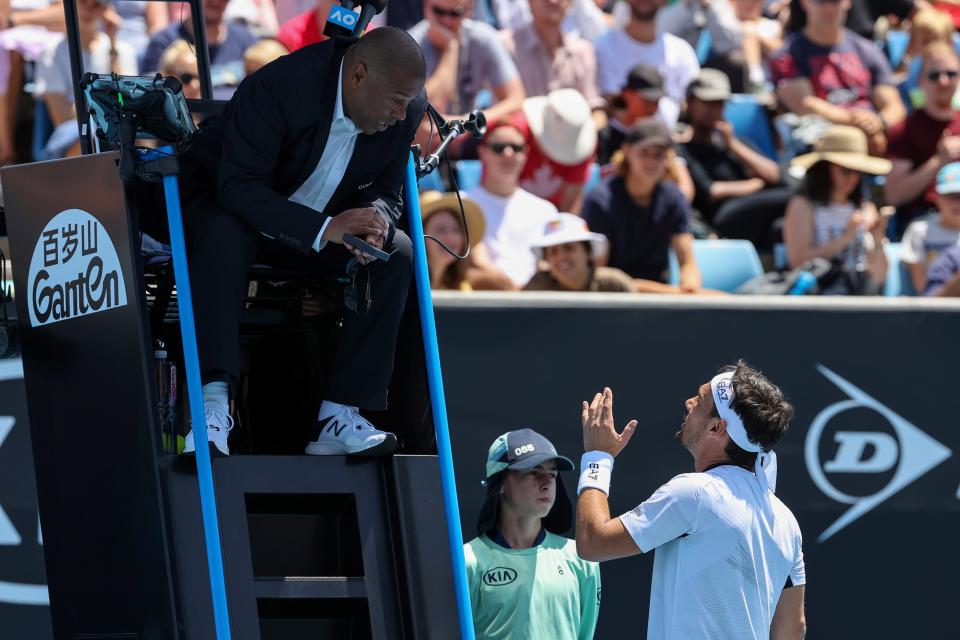 Italy's Fabio Fognini speaks to the umpire after a point against Reilly Opelka of the US during their men's singles match on day two of the Australian Open tennis tournament in Melbourne on January 21, 2020. (Photo by DAVID GRAY / AFP)