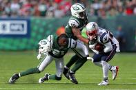 <p>New York Jets corner back Morris Claiborne (21) loses his helmet as he and New York Jets linebacker Darron Lee (58) tackle New England Patriots running back James White (28) during the third quarter at MetLife Stadium. Mandatory Credit: Brad Penner-USA TODAY Sports </p>