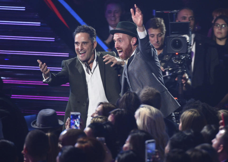 Jorge Drexler, left, and Jesus Martos react in the audience as Drexler is announced winner of the award for record of the year for "Telefonia" at the Latin Grammy Awards on Thursday, Nov. 15, 2018, at the MGM Grand Garden Arena in Las Vegas. (Photo by Chris Pizzello/Invision/AP)