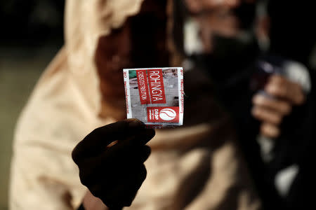 A Rohingya refugee displays a token used to receive aid in Cox's Bazar, Bangladesh, September 21, 2017. REUTERS/Cathal McNaughton